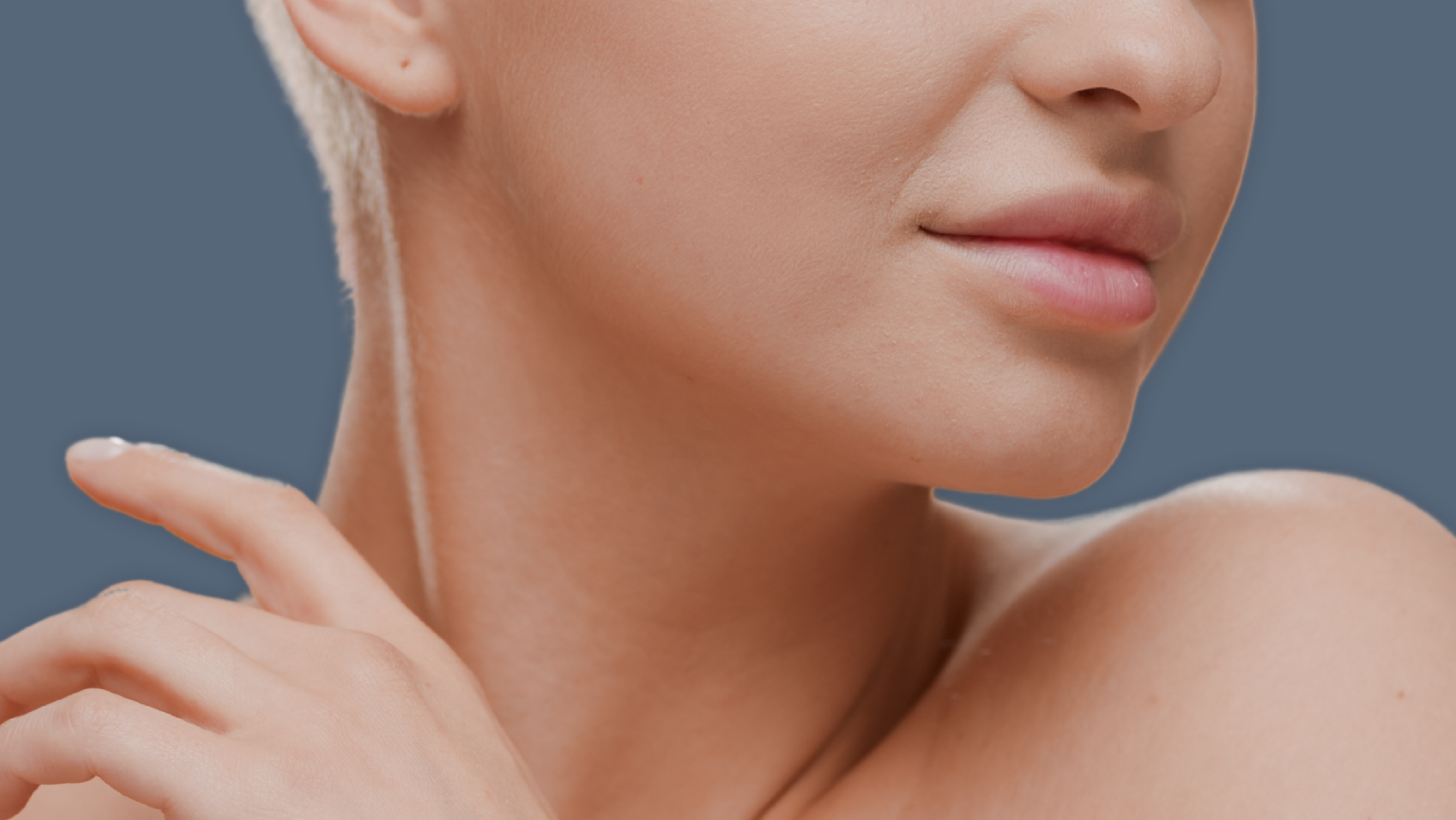 Close up of a woman's nose and mouth with healthy skin after aesthetic treatment